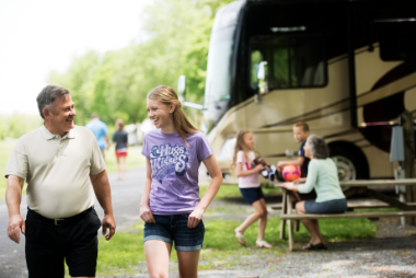 Father and daugther walking around Hersheypark Camping Resort in front of their RV.