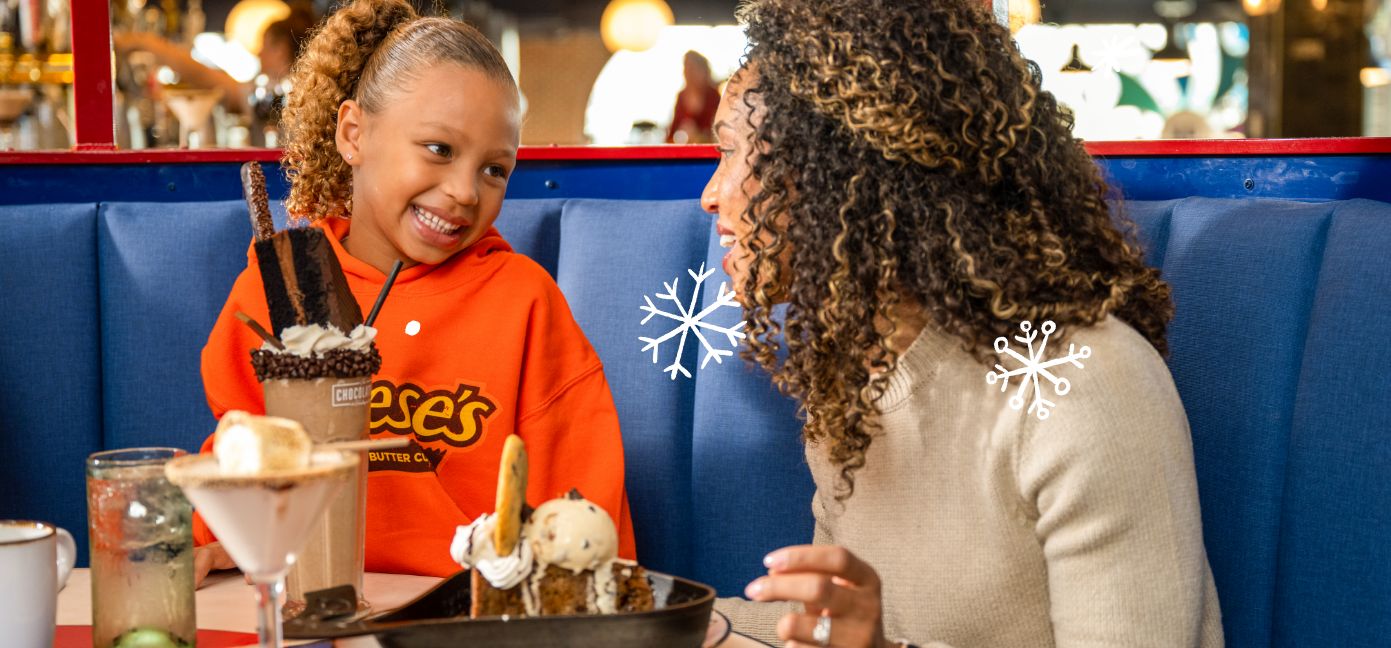 Mother and daughter sharing a milkshake and other dessert at The Chocolatier.