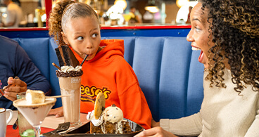 Mother and daugther enjoying milkshakes at The Chocolatier.